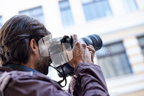 Image of Photographer, work and man in city for travel, journey and filming memory of adventure with camera. Professional, cameraman and person capture creative photography with lens outdoor in photoshoot