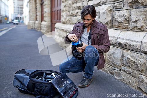 Image of Clean, camera lens and photographer work with equipment outdoor and prepare for photoshoot in city. Cameraman, wipe and start project with gear for photography on town street for professional media