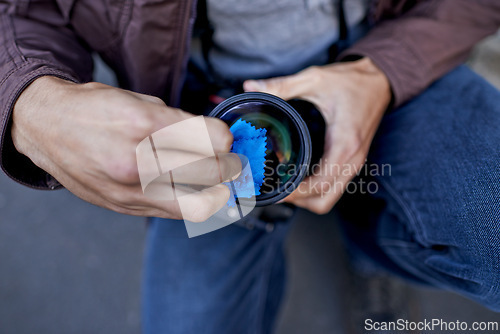 Image of Clean, camera and lens in hands of photographer to prepare equipment for photoshoot and process. Cameraman, closeup and wipe gear to start photography outdoor with care for professional technology