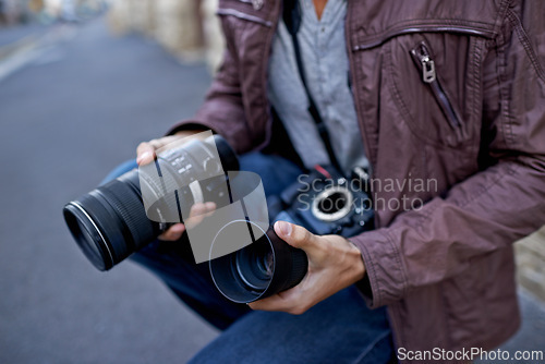 Image of Camera lens, outdoor and hands of photographer to work in city on photoshoot with professional gear to film on street. Shooting, photography and cameraman closeup with tech to capture media in town