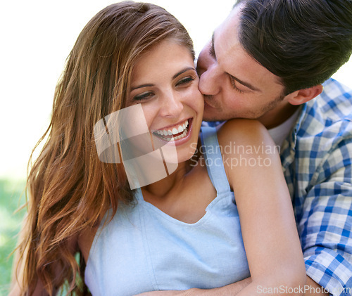 Image of Man, woman and embrace with kiss in park for holiday bonding in summer for relax, partnership or love. Happy couple, hug and cheek in backyard garden or nature for vacation date, sunshine or outdoor