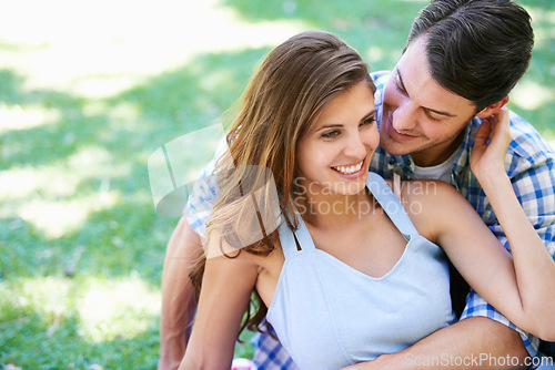 Image of Man, woman and embrace on grass in park for holiday bonding in summer for relax, partnership or love. Happy couple, hug and ground in backyard garden in nature for vacation date, lawn or sunshine