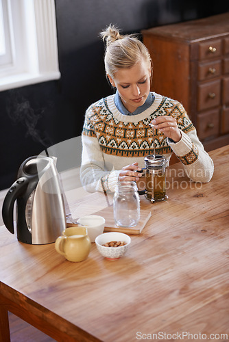 Image of Woman, kitchen and herbal tea in home for health and warm drink with plant leaf mixture for wellness. Above, designer and morning with dried leaves in plunger and calm for detox beverage in apartment