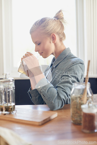 Image of Woman, herbal tea and relax or leaves in jar at home or healthy digestion or smell, drinking or calming. Female person, dry herbs and kitchen with jasmine or plant for ingredients, brewing or aroma