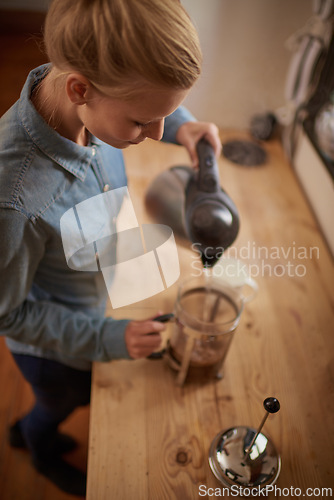 Image of Woman, coffee and french press our pour water from kettle in kitchen for morning, beverage or preparation. Female person, plunger and counter from above in apartment or caffeine, espresso or drink