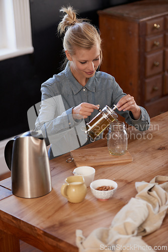 Image of Woman, happy and tea of herbs in home and warm beverage of herbal mixture for health wellness. House, homeopath and detox with dry leaves in plunger and chamomile drink to relax in kitchen by table