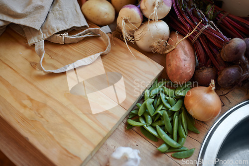 Image of Vegetables, vegan and wooden board for cooking lunch, dish and nutrition for diet at home. Wellness, health and organic food with meal, vegetarian and green ingredients for salad in a kitchen