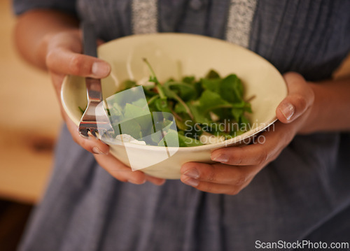 Image of Hands, salad bowl and lettuce for healthy nutrition with vegetables in kitchen or recipe, wellness or hungry. Person, fingers and fork for organic eating or leafy greens for ingredients, dish or meal