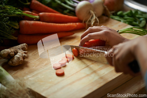 Image of Vegetables, hands and person with knife and carrot cut and for cooking lunch and nutrition diet at home. Wellness, health and organic food with meal, vegetarian and ingredients for salad in a kitchen