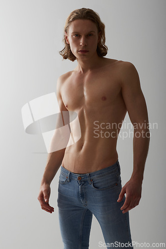 Image of Shirtless, model and portrait of man in jeans on studio, white background and mockup with fashion. Male, beauty and topless person with abs in denim pants, cool style and confidence in backdrop