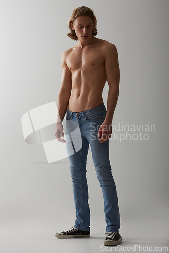 Image of Shirtless, model and man in jeans on studio, white background and mockup with fashion. Male, beauty and handsome topless person with abs in denim pants, cool style and confidence in backdrop