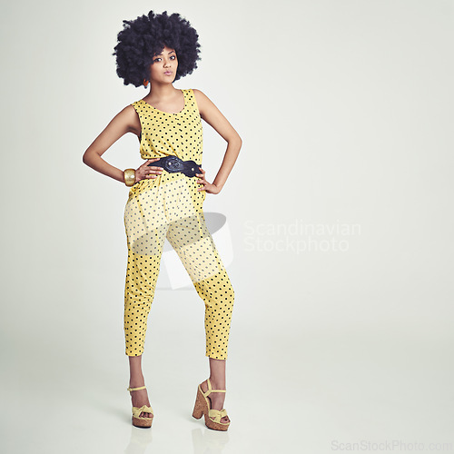 Image of Black woman, portrait and retro fashion in studio for vintage, unique look and jumpsuit. African girl, stylish and gen x with curly hair afro, confident and pose with white background for mockup