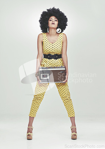 Image of Black woman, fashion in studio with radio in jumpsuit, white background, afro and vintage. Colour, attitude and trendy with style in fancy clothes, heels and beauty with confidence and retro