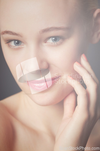 Image of Skincare, hand and portrait of woman in makeup to glow isolated on a dark studio background. Face, touch and beauty of young model in cosmetics, manicure and spa facial treatment for smooth skin