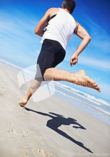 Image of Man, running and water at beach with fitness, sport and training for marathon by the sea. Workout, exercise and back of athlete with health and wellness outdoor of runner with cardio in summer