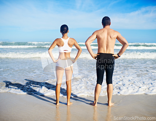 Image of Couple, sea and fitness with swimming, training and exercise for race in summer by the beach. Back, athlete and workout of people by the ocean in Miami for health and wellness outdoor for sport