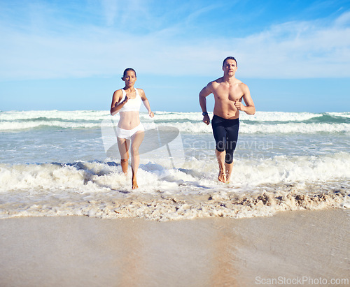 Image of Running, beach and couple with fitness, waves and weekend break with cardio and training for health. Runners, seaside and man with woman and support with practice and activity for wellness and hobby