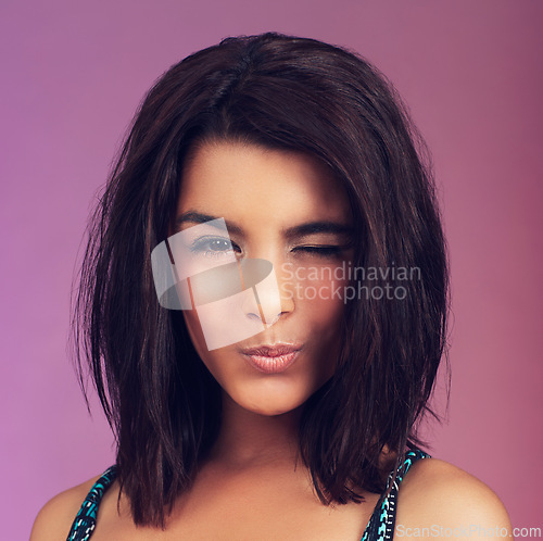 Image of Studio, woman and makeup with wink, portrait and youth for beauty, model and individuality. Latino person, pink background and hairstyle for modern, hipster and cool with trendy, smile and confidence