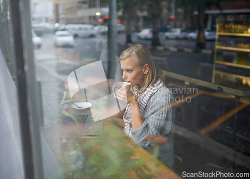 Image of Coffee shop, laptop and woman with drink for remote work in window for internet, website and research. Restaurant, relax and girl on computer for freelance career, working and email with cappuccino