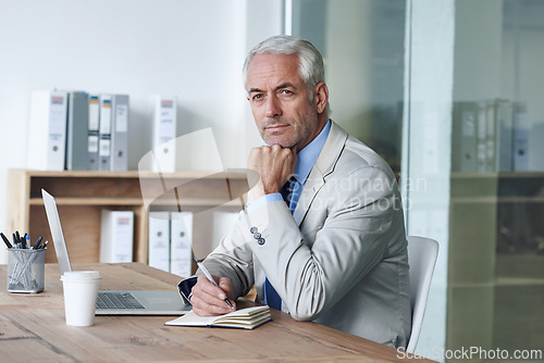 Image of Senior, businessman and writing, laptop and portrait at desk in the office for consultant notes. CEO, man and plan for budget, payroll and human resources for company in diary for startup proposal