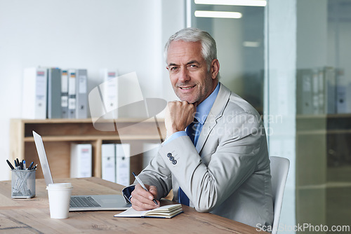 Image of Senior, businessman and smile, laptop and portrait at desk in the office for consultation. CEO, man and plan for budget, payroll and human resources and writing in company for startup proposal