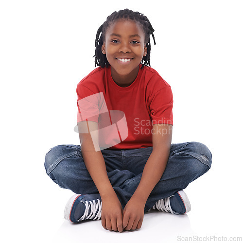 Image of Boy, child and portrait, smile in studio with casual clothes for fashion, positive mood and childhood on white background. T-shirt, jeans and simple outfit, African kid or youth sitting down