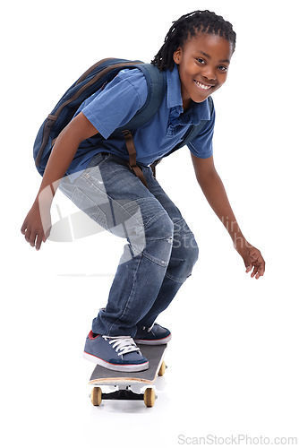 Image of Skateboard, student or portrait of African kid in studio with smile, skill or trick with bag or cool style. Skater, performance or happy child skateboarding with energy isolated on white background