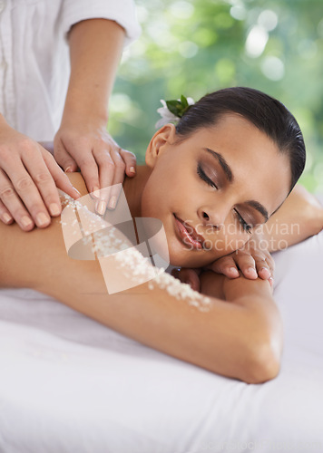 Image of Woman, massage and body scrub in spa, detox and cosmetic sugar treatment for skin care in salon. Person, relax or cosmetology by masseuse for dead cells, calm or wellness with healing hands on bed