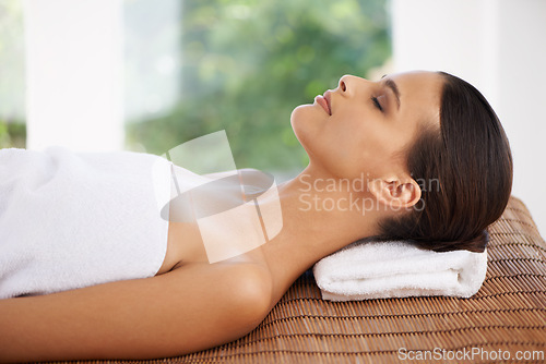 Image of Woman, wellness and relax in spa on bed, sleeping and beauty of body care and pamper treatment. Person, rest and peace with health in salon, zen and natural skincare on travel at holiday resort