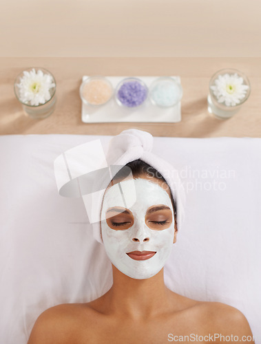 Image of Woman, face mask and cosmetology for beauty in spa, detox and cosmetic treatment for salon facial. Person, relax and aromatherapy with natural clay on skin, calm and skincare for dermatology on bed