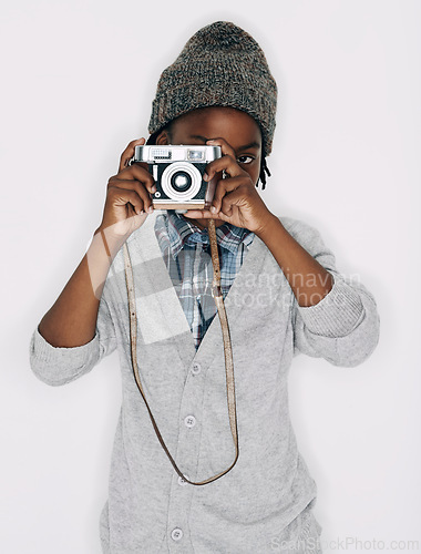 Image of Photographer, portrait or child in studio with camera isolated on white background for creative talent. Photography, African boy or cool kid artist with hobby, style or picture ready for photoshoot