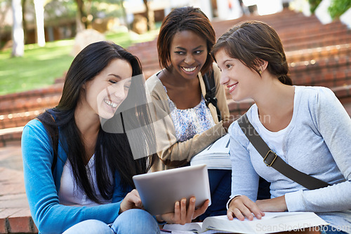 Image of University, students and women with a tablet, outdoor and sunshine with smile and teamwork with online research. People, academy and girls on break and tech for a project, digital app and cooperation