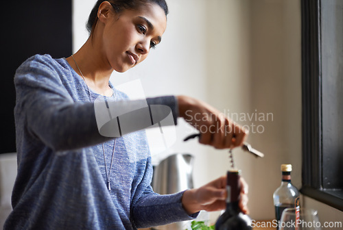 Image of Woman, opening wine and bottle for dinner, evening meal with corkscrew and preparing to drink for enjoyment and nutrition. Alcoholic beverage, tools or equipment with cooking for dining in kitchen