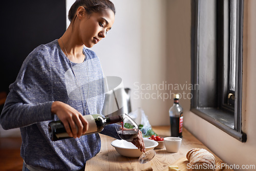 Image of Woman, pour wine and home for dinner, relax for peace and leisure with drink in kitchen. Alcohol, glass and bottle with refreshment, hydration with beverage to celebrate or chill in apartment