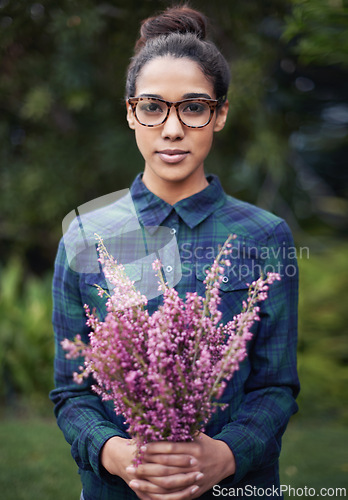 Image of Woman, flower bouquet and portrait in garden, nature and blossom with environment, relax in Spring with gift outdoor. Purple plant, present and botanical with sustainability and romantic gesture