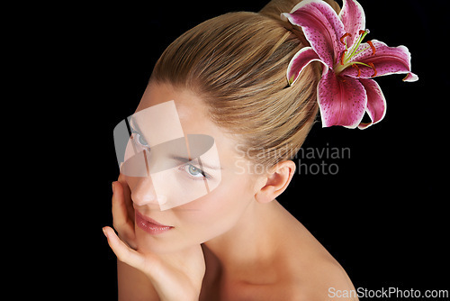 Image of Hair care, flower and woman touch skin, thinking and beauty isolated on a black studio background. Natural, floral makeup and hand of model in cosmetics, salon and lily for organic facial treatment