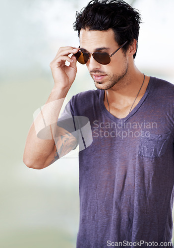 Image of Fashion, sunglasses and man outdoor with confidence, cool style and pride in Miami. Summer, holiday and person with serious face in casual outfit for vacation in Florida and relax in sunshine