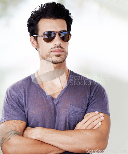 Image of Fashion, sunglasses and man outdoor with arms crossed, confidence and cool style on vacation. Summer, holiday and person with serious face in casual aesthetic in Miami and pride in Florida sunshine