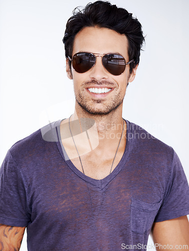 Image of Happy, portrait and man with fashion in sunglasses on studio, white background with confidence. Summer, holiday and person smile in casual outfit for vacation and relax in cool style with pride