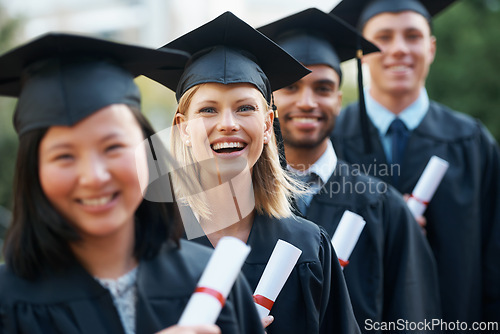 Image of College, graduation and portrait of group at ceremony with diploma, certificate and happiness in line. University, success and class of people with achievement of degree in education on scholarship