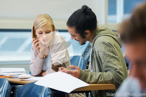 Image of Discussion, university and students in classroom for studying with text book for test or exam. Conversation, writing and young people working on college assignment together in lecture hall at academy