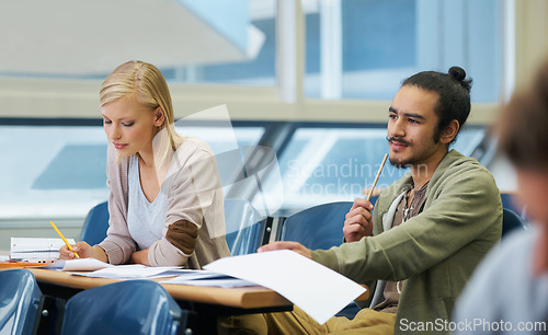 Image of Lecture, university and students in classroom for studying with text book for test or exam. Education, scholarship and young friends learning write for college assignment together in hall at academy.