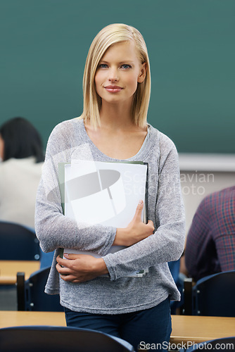 Image of Student, classroom and portrait of woman in college for study, learning and development at campus. Female person, confident and paper for education, knowledge or academic growth at university