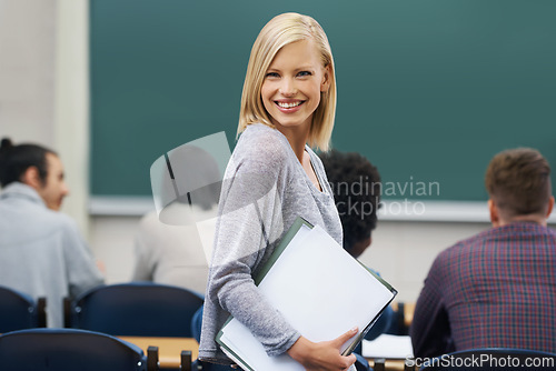 Image of Woman, smile and portrait of teacher in classroom with students for learning, knowledge and development. Female lecturer, happy and confident with notebook for education, training or academic career