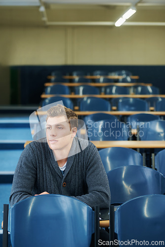 Image of Thinking, university and man student in classroom brainstorming for exam studying ideas. Planning, education and young male person in lecture hall with question for college assignment at academy.