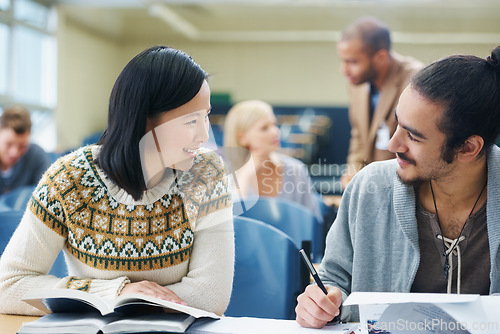 Image of Discussion, college and students in classroom for studying with text book for test or exam. Conversation, writing and young people working on university assignment together in lecture hall at academy