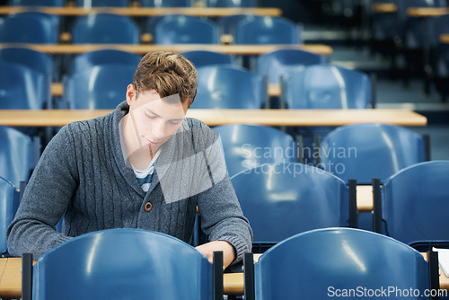 Image of Lecture hall, thinking and man with university, student and college with exam and education. Person, writing and guy in classroom with test and learning with studying and creativity with knowledge