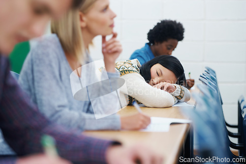 Image of Student, university and sleeping on desk in classroom for boring lecture or burnout, fatigue or scholarship. People, college and diversity with research paper in USA for learning, knowledge or tired