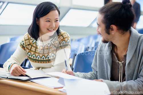 Image of Conversation, college and students in classroom for studying with text book for test or exam. Discussion, writing and young people working on university assignment together in lecture hall at academy