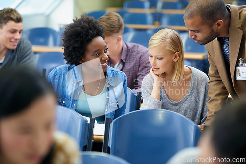 Image of University student, teacher and classroom or test help in lecture hall or education, scholarship or learning. Female people, friends and professor or paperwork at college academy, teaching or London